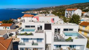 a house with a view of the water at Aquarelle Apartments Primošten apt no 1 and 3 in Primošten