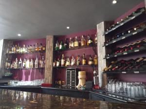 a bar with a lot of bottles of alcohol at Hotel Tlahuac in Mexico City