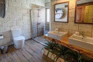 a bathroom with two sinks and a shower at Vasiliou House in Khandria +18 photos