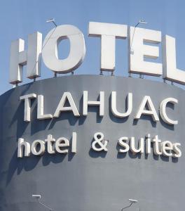 a large sign for a hotel and suites at Hotel Tlahuac in Mexico City