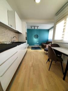a kitchen and living room with a table and a couch at Aleksandar First Sea Line Apartment in Bar