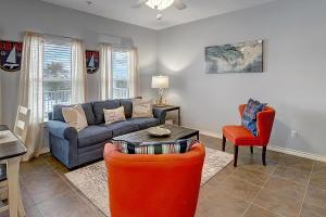 a living room with a couch and a table and chairs at X Marks The Spot in Port Aransas