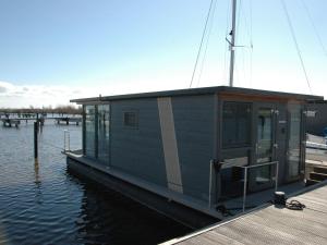 eine kleine Hütte auf einem Boot im Wasser in der Unterkunft Beautiful Houseboat in the harbour of Volendam near Centre in Volendam
