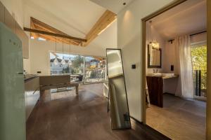a kitchen with a stainless steel refrigerator in a room at latemar - schlosserhaus 31 in Tesimo +13 photos