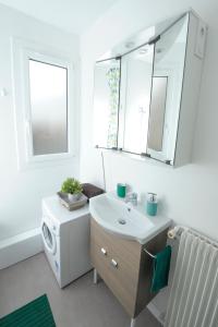 a bathroom with a sink and a washing machine at STUDIO Cosy et fonctionnel, proche de Paris in Villeneuve-la-Garenne