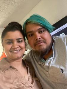 a man with green hair and a woman posing for a picture at Budget Inn Express in Louisa