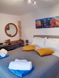 a bedroom with a bed with two towels on it at Villa Venetia Corfu in Agnítsini