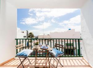 a balcony with a table and chairs on a roof at Luxury Diving Apartment in Puerto del Carmen