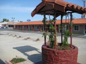 a brick planter with plants in it in a parking lot at Americas Best Value Inn - Porterville in Porterville
