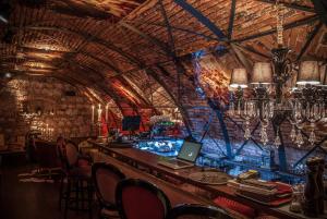 a bar with a laptop on top of it at Casa Albert Boutique & Restaurant in Braşov