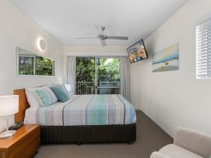 un dormitorio con una cama y una ventana en Picture Point Penthouse 11 - Private Rooftop Spa, en Noosa Heads 10 fotos más