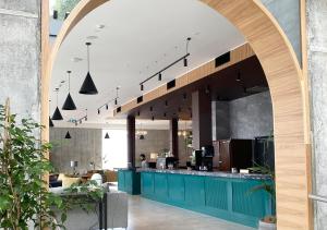 奥克兰Sudima Auckland City的拱门通往带柜台的餐厅