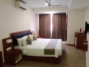 a bedroom with a large bed in a room at HOTEL GEO in Cochin