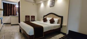 a bedroom with a large bed in a room at Rmc travellers inn in Chennai
