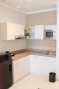A kitchen or kitchenette at The Bellezza Hotel Suites