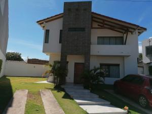 a house with a red car parked in front of it at El Prado in Santa Cruz de la Sierra