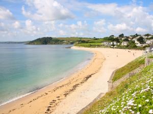 a view of a beach with people on it at Through The Porthole in Falmouth