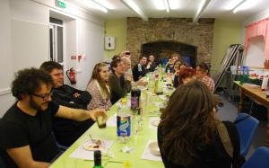 a group of people sitting around a long table at Dulverton Hostel in Dulverton