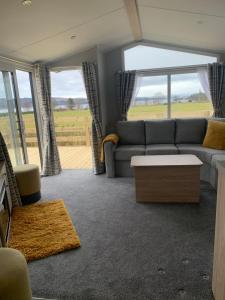 a living room with a couch and a table at The Castleton in Dunoon