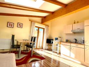 a kitchen and dining room with a table and chairs at Apart Huditz in Zell am Ziller