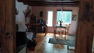 a living room with a table and a dining room at Podlaskie Żuczki in Żuki