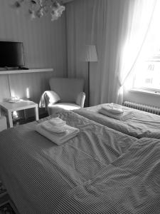 a hotel room with a bed with towels on it at Kyykerin Kartano in Outokumpu