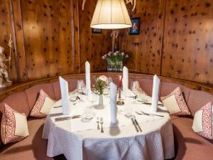 a table with a white table cloth and candles on it at Hotel Gasthof Blaue Quelle in Erl