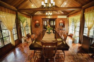 uma grande sala de jantar com uma mesa longa e cadeiras em Malagos Garden Resort em Davao