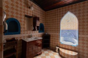 a bathroom with a sink and a window at Dhow Palace Hotel in Zanzibar City