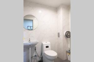 uma casa de banho com um WC, um lavatório e um espelho. em Khoksametchun Hostel Plus em Hat Yai