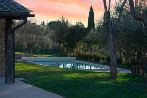 a swimming pool in the middle of a yard at Il Miraggio in Val d'Orcia Relais & Spa in San Quirico dʼOrcia