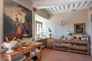 a room with a large painting on the wall at Il Miraggio in Val d'Orcia Relais & Spa in San Quirico dʼOrcia