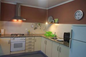 a kitchen with a white refrigerator and a sink at Salicornia terrassa in Amposta