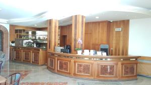 a bar in a restaurant with wood paneling at Hotel Alla Dolina in Sistiana