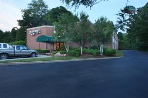 a building with a truck parked in front of it at Rosemont Suites in Norwich