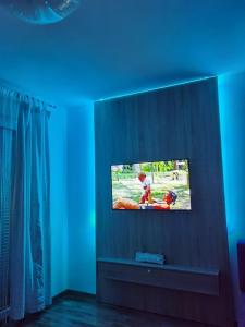 a television in a room with a blue ceiling at Apartman Krasula Doboj in Doboj