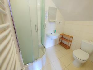 a bathroom with a shower and a toilet and a sink at Zajazd PTTK Pod Roztoką in Rytro