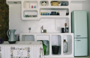 a kitchen with a refrigerator and a table in a room at Heyblue Aura Seaside Villa - Unique escape in Naxos Chora +20 photos