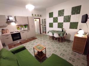 a living room with a table and a kitchen at I colori di Otranto by CASASI Vacanze Otranto in Otranto