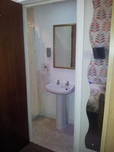 a bathroom with a sink and a vase at The Chorlton by Cherish Lewis Hotel in Blackpool +25 photos