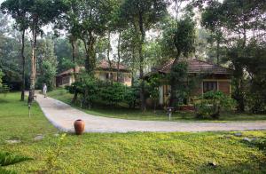 a house in a park with a path leading to it at Agraharam Resorts in Thirunelli