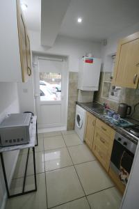 a small kitchen with a sink and a stove at Molesey near Hampton Court, Viking Short Stays in West Molesey