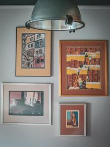 a group of pictures hanging on a wall at Hungry Grape Guests in Erdőbénye