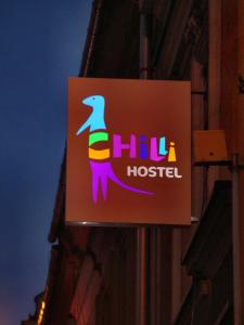 a sign for a chiu hostel on the side of a building at Chilli Hostel in Krakow