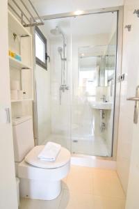 a white bathroom with a shower and a toilet at Letmalaga Economy Jábega in Málaga