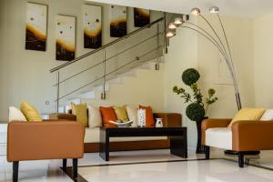 
a living room with a couch, chairs and a table at H177 Hotel in Campeche
