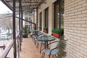a patio with tables and chairs on a building at Hotel Bashnya in Kislovodsk