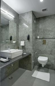 a bathroom with a sink and a toilet at Hotel khumani By Hills N Dunes in Udaipur