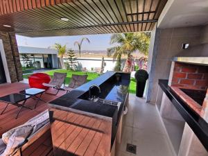 a kitchen with a black sink and a patio at G R A N D C H A L E T in Salalah