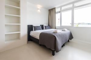 Postel nebo postele na pokoji v ubytování Houthavens Apartments
